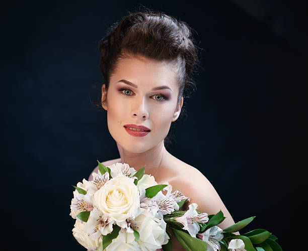 istock Young cute smiling woman with a bouquet 471936160