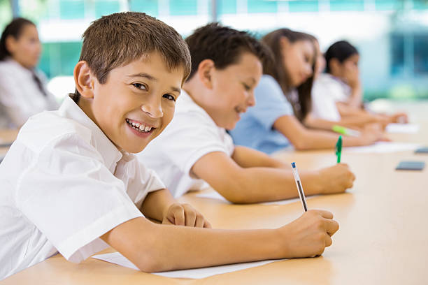 istock Preteen students wearing private school uniforms in classroom 471936257