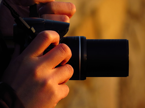 photographer and his zoom camera at sunset