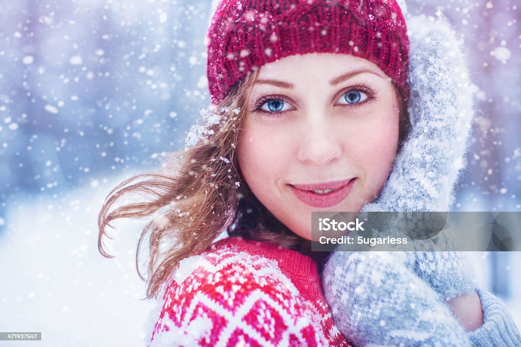 Beautiful woman enjoying winter Young beautiful woman enjoying snowing Human Hair Stock Photo