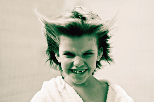 Portrait of a little  boy that looks like a devil. Selective soft focus. Toned and desaturated photo.