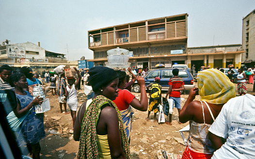Luanda, Luanda Province, Angola – August 10, 2003: Crowds in the suburbs of Luanda, Angola. Almost no infrastructure was built or maintained during the 25 years of civil war, leaving the city overcrowded and decrepit.