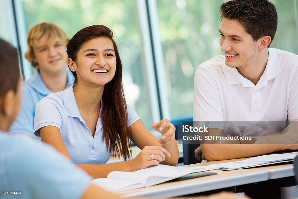 Student answering teacher's question in private high school classroom Adolescence Stock Photo