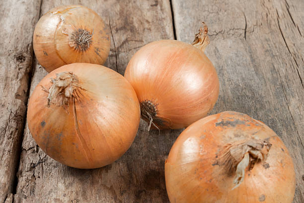 istock Onions on an old wooden background 471942101