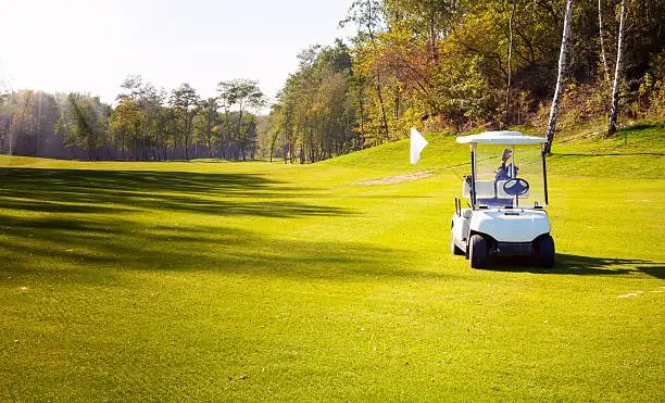 Golf-cart car on grass field of golf course