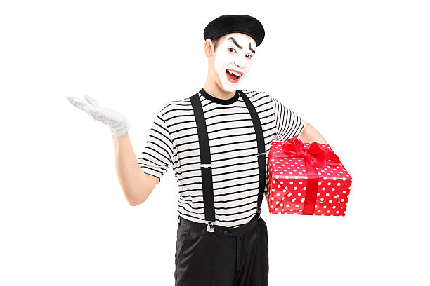 istock Male mime artist holding a gift box 471943259