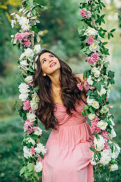Beautiful young girl on a swing