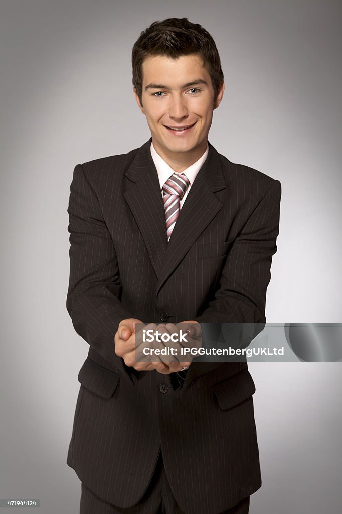 Young caucasian businessman with cupped hands 20-24 Years Stock Photo