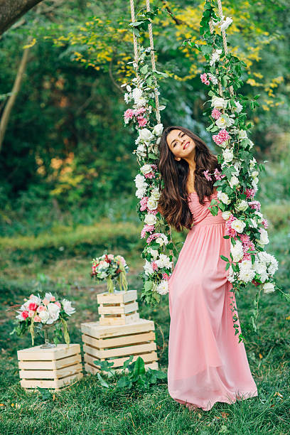 istock Beautiful young girl on a swing 471944178
