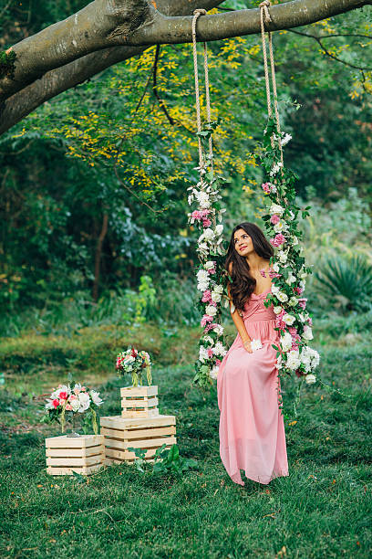 istock Beautiful young girl on a swing 471944184