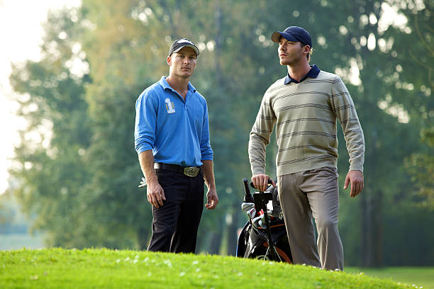 Young golfer using the driver golf club to start the hole