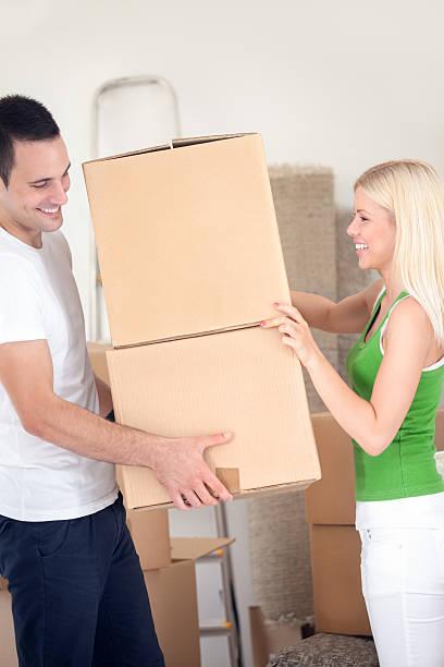 istock couple moving into a new home with boxes. 471944377
