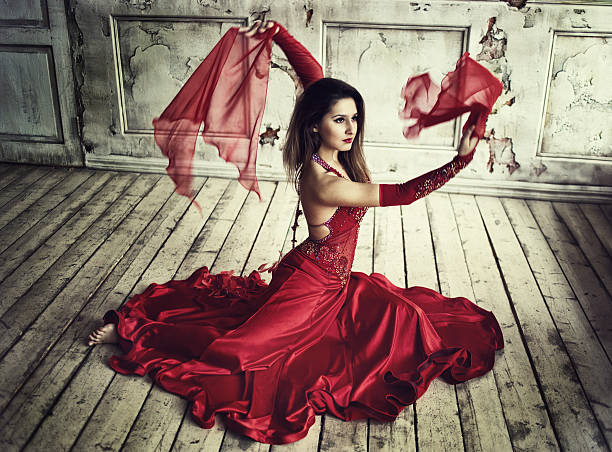 Beautiful woman in red dress dancing