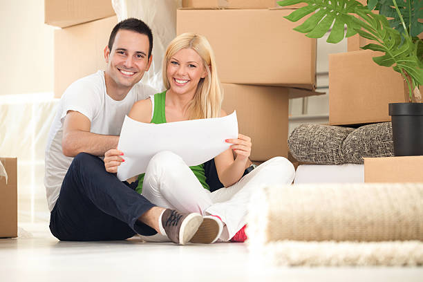 istock Young happy couple moving into their new home 471944501