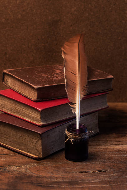 istock old books, scrolls, feather pen and inkwell on wooden table 471944968