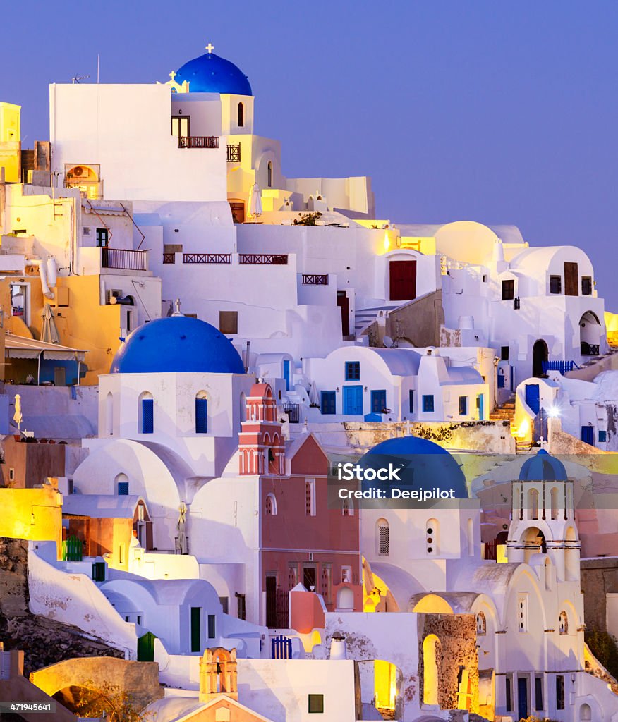 Blue Domed Church in Oia Village on Santorini Island Greece The village of Oia on Santorini island at twilight, Greece. Architectural Dome Stock Photo