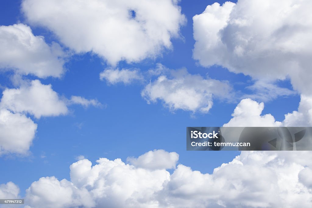 Fluffy clouds drifting over a blue sky Heavenly blue sky with puffy clouds 2015 Stock Photo