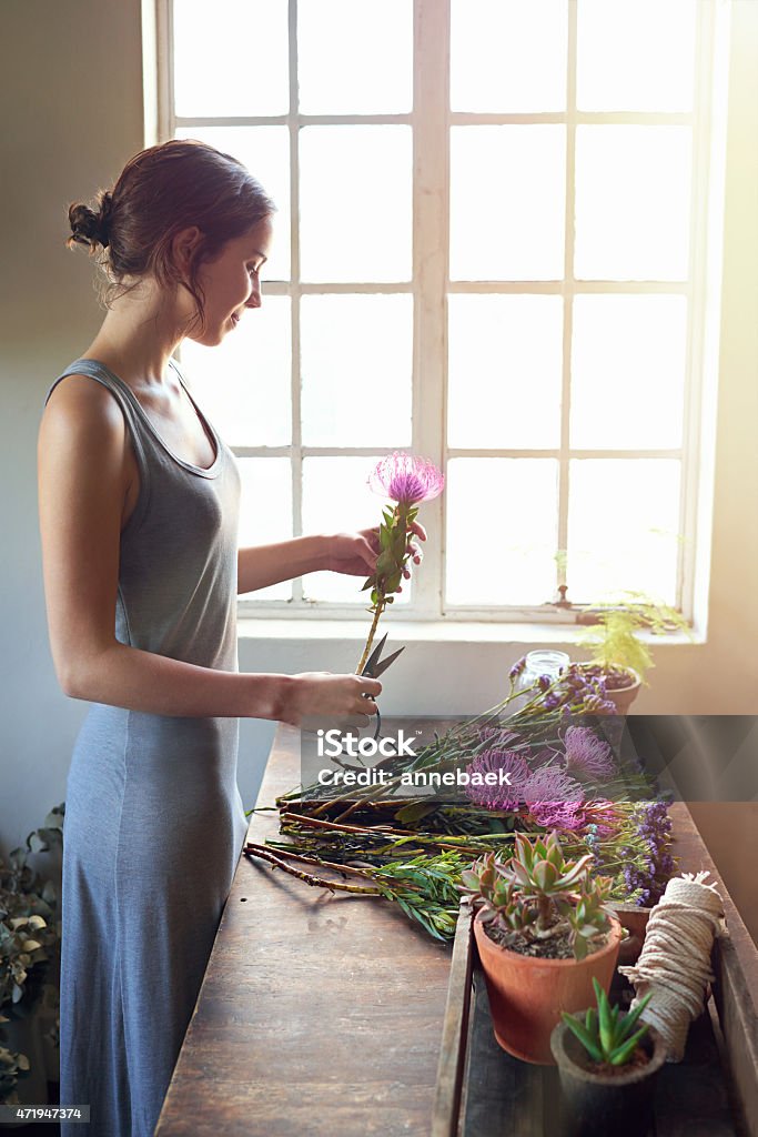 Creativity is intelligence having fun Shot of a young florist cutting flowers to make up a bouquethttp://195.154.178.81/DATA/i_collage/pu/shoots/804525.jpg 20-29 Years Stock Photo