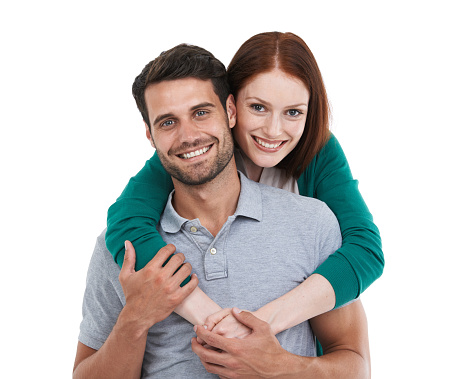 Attractive young couple in love, man carrying woman pickaback, smiling happily...