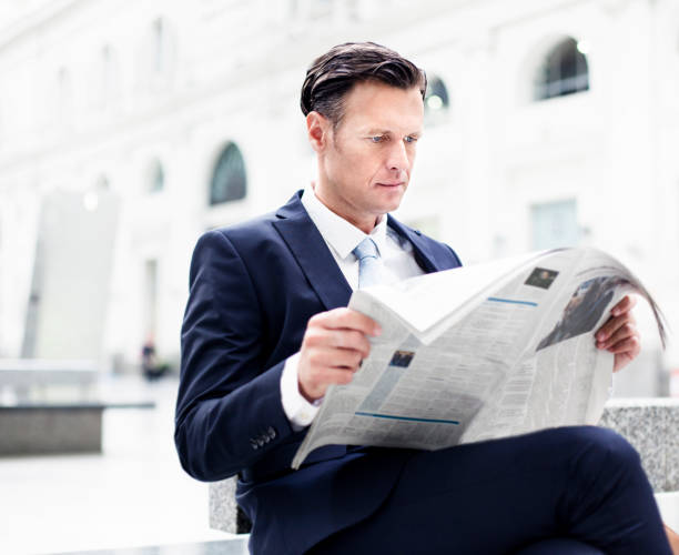 istock Businessman reading newspaper 471948291