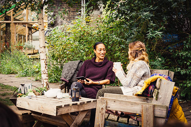 Two Friends Take Tea In The Garden.