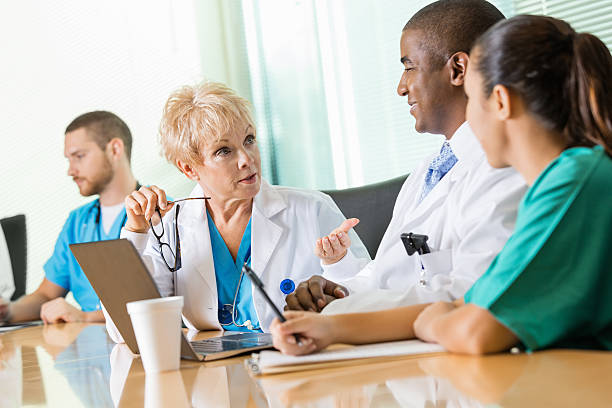 istock Senior female physician discussing policy changes with other doctors 471949497