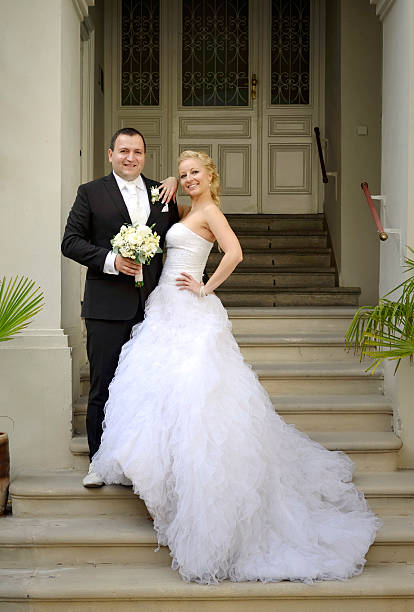 istock Newlywed couple posing on stairs 471949683
