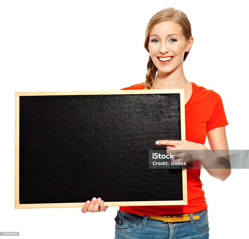 Happy student with blackboard Portrait of college student standing with small blackboard and smiling at the camera. Studio shot, white background. 18-19 Years Stock Photo