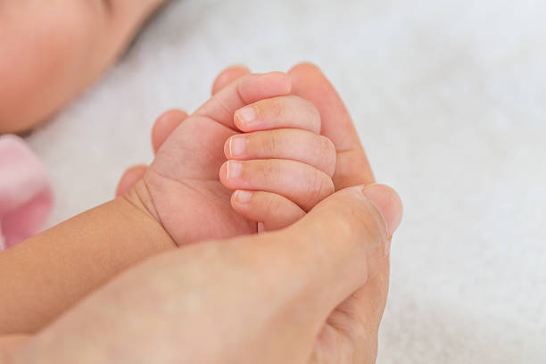 istock New born baby hand 471950166