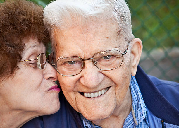 istock Senior Man Getting Kiss From Wife On Cheek 471950233