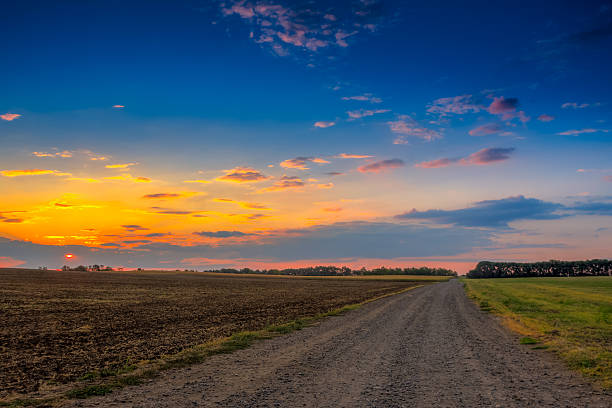 istock Road in meadows and beautiful sunset 471950389