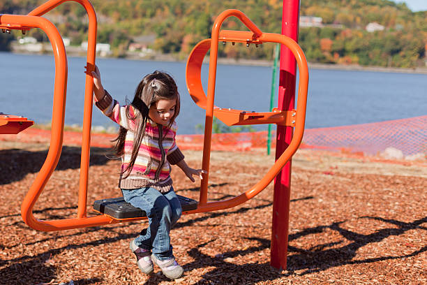 Little girl playing at the park. stock photo