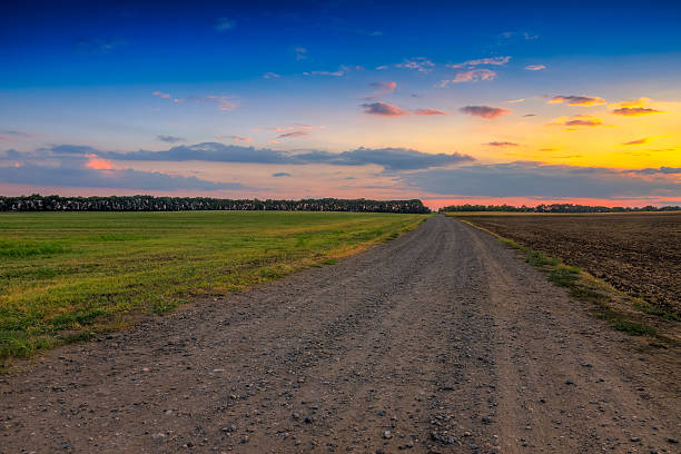 istock Road in meadows and beautiful sunset 471950519