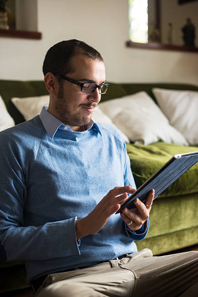 istock elegant business multitasking multimedia man at home 471950583
