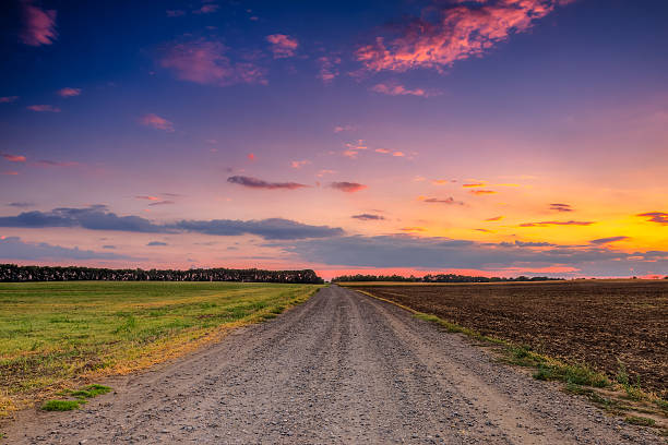 istock Road in meadows and beautiful sunset 471950613