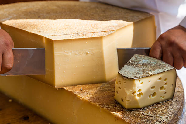 istock Man cutting piece of cheese 471950646