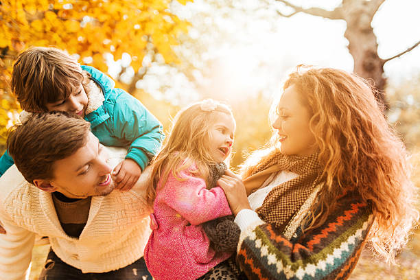 istock Young parents having fun with their children in autumn. 471950764