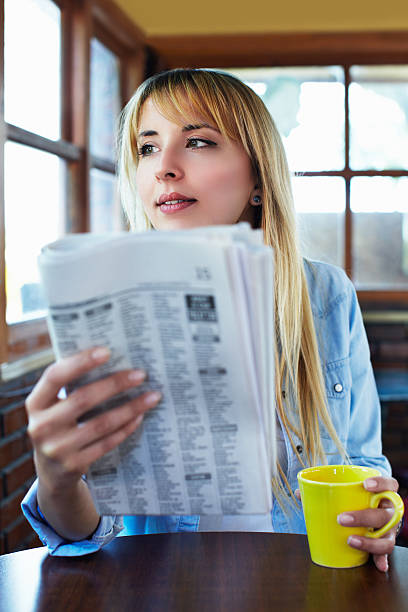 istock Woman reading newspaper 471950819