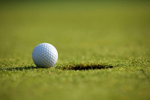 istock Golf ball near hole 471951160