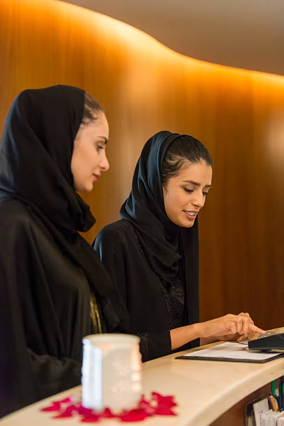 istock Middle Eastern Woman at Counter Paying by Credit Debit Reader 471951334