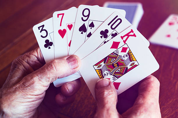 istock Pensioner Playing With Large Print Playing Cards 471952954