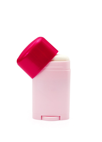 Pink bottle with deodorant isolated on white