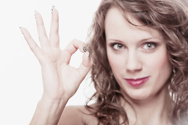 istock Young woman gesturing ok okay hand sign 471954033