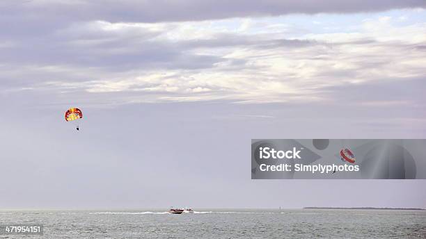 Tourists Out Parasailing Stock Photo - Download Image Now - Cloud - Sky, Dusk, Excitement