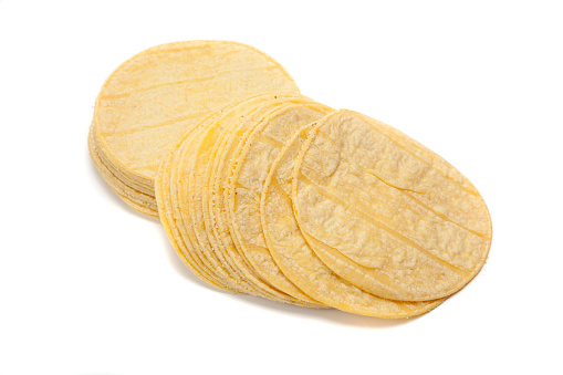 A stack of corn tortillas on a white background