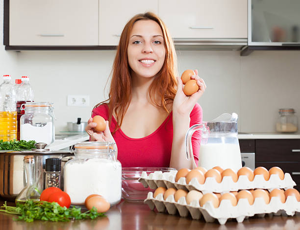 istock Cheeful housewife in red with eggs 471954521