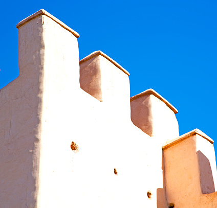 old ruin in  brown construction  africa         morocco and sky  near the tower