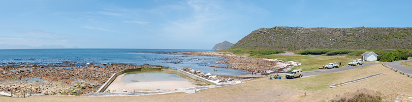 Cape Town, South Africa - December 12, 2014: Beach scene at Bordjiesrif in the Cape Point section of the Table Mountain National Park. Cape Point is in the distance