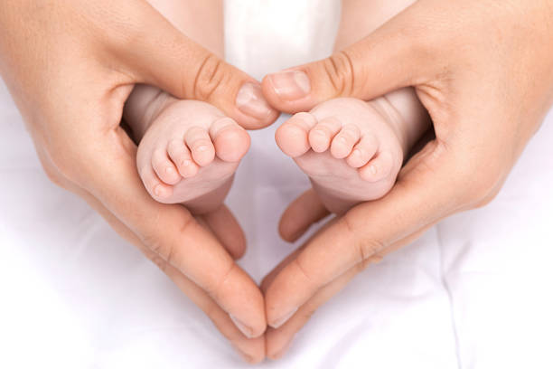 istock Heart Around Newborn Feet. 471957667