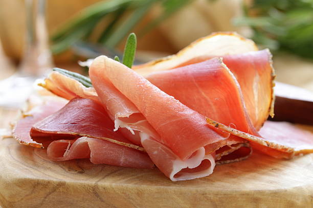 istock parma ham (jamon) sliced on a wooden board 471958297